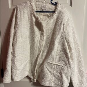 Jaclyn Smith’s collarless tweed jacket in a cream or off-white color.